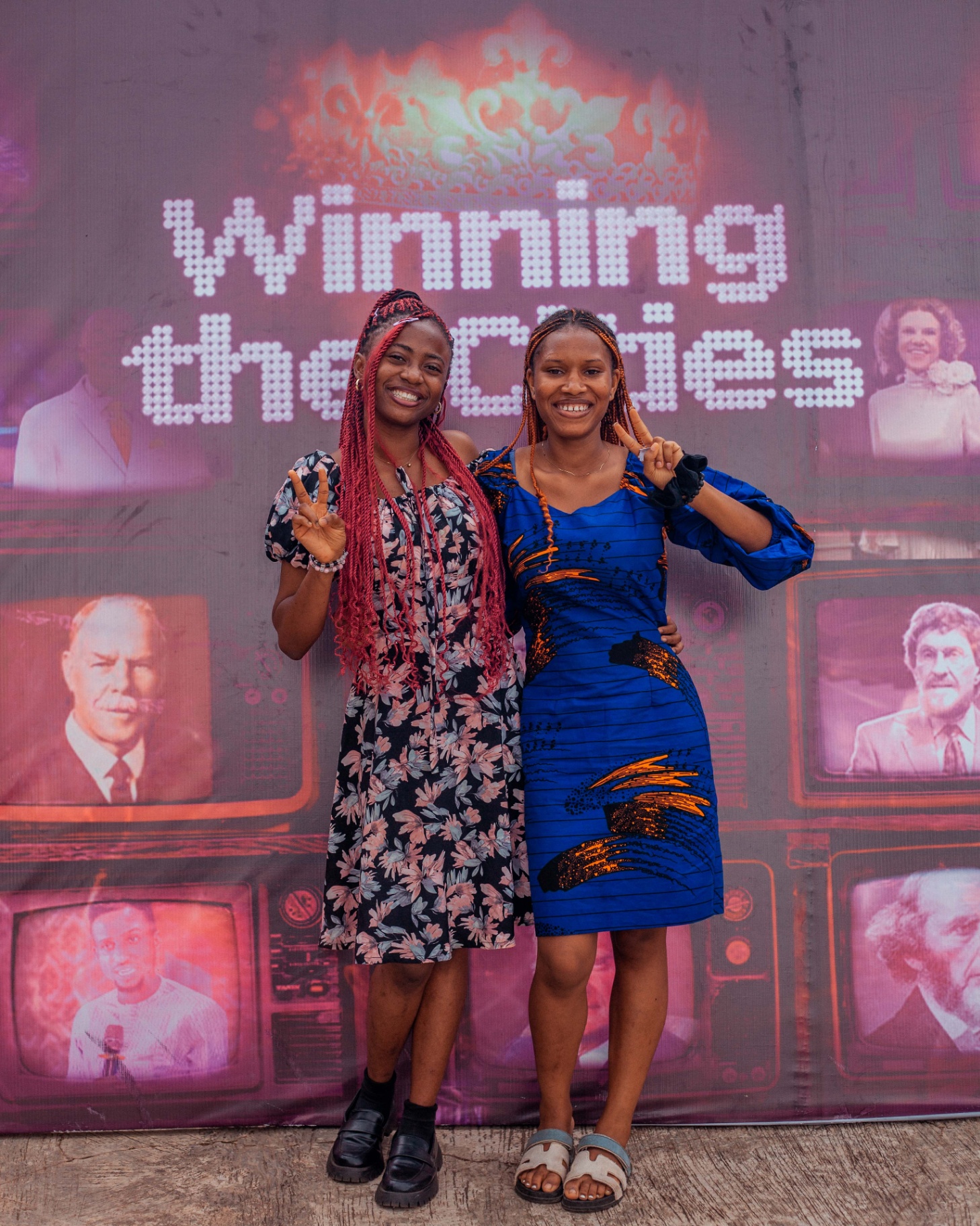 Two sisters at the Winning the Cities backdrop