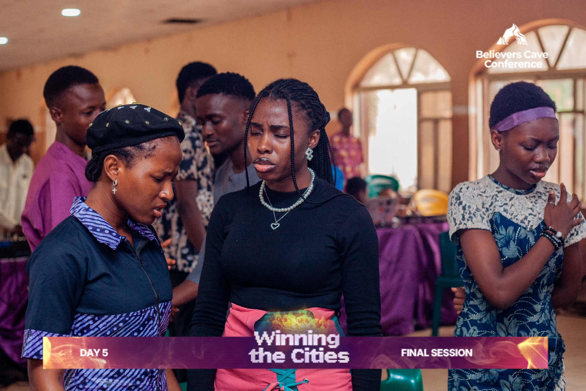 Sisters ministering in prayer during Winning the Cities final session